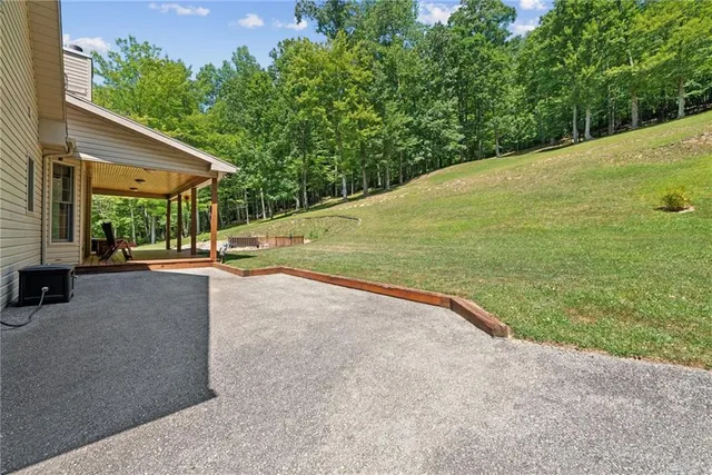 a spacious bedroom with a bed and a flat screen tv