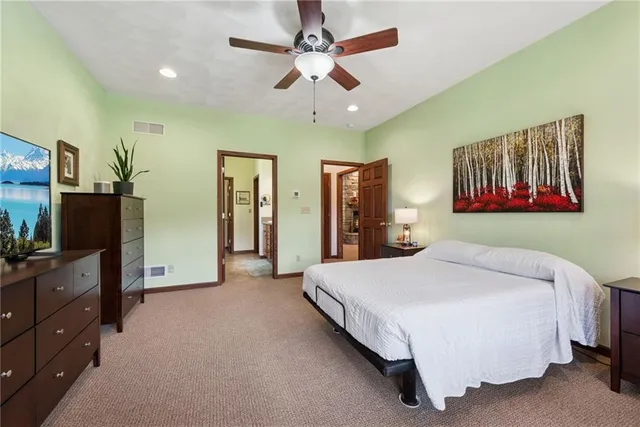 a bedroom with a large bed and a chandelier