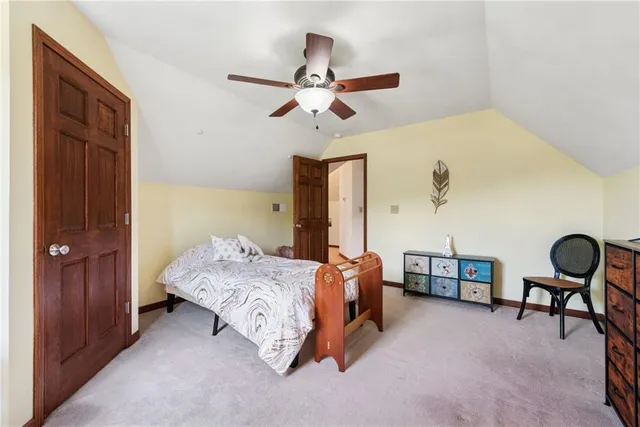 a bedroom with a bed dresser and a window