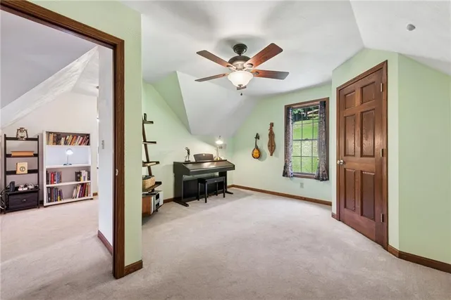 a view of a livingroom with a piano and wooden floor