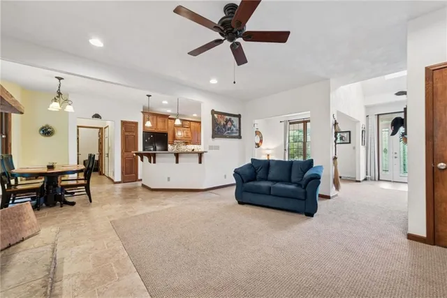 a living room with furniture and kitchen view