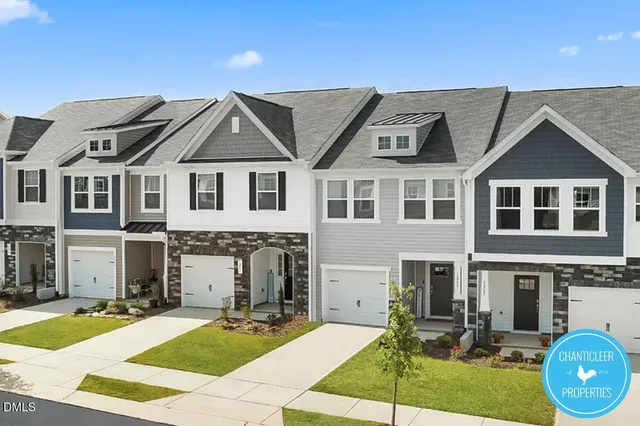 a front view of a house with yard and green space