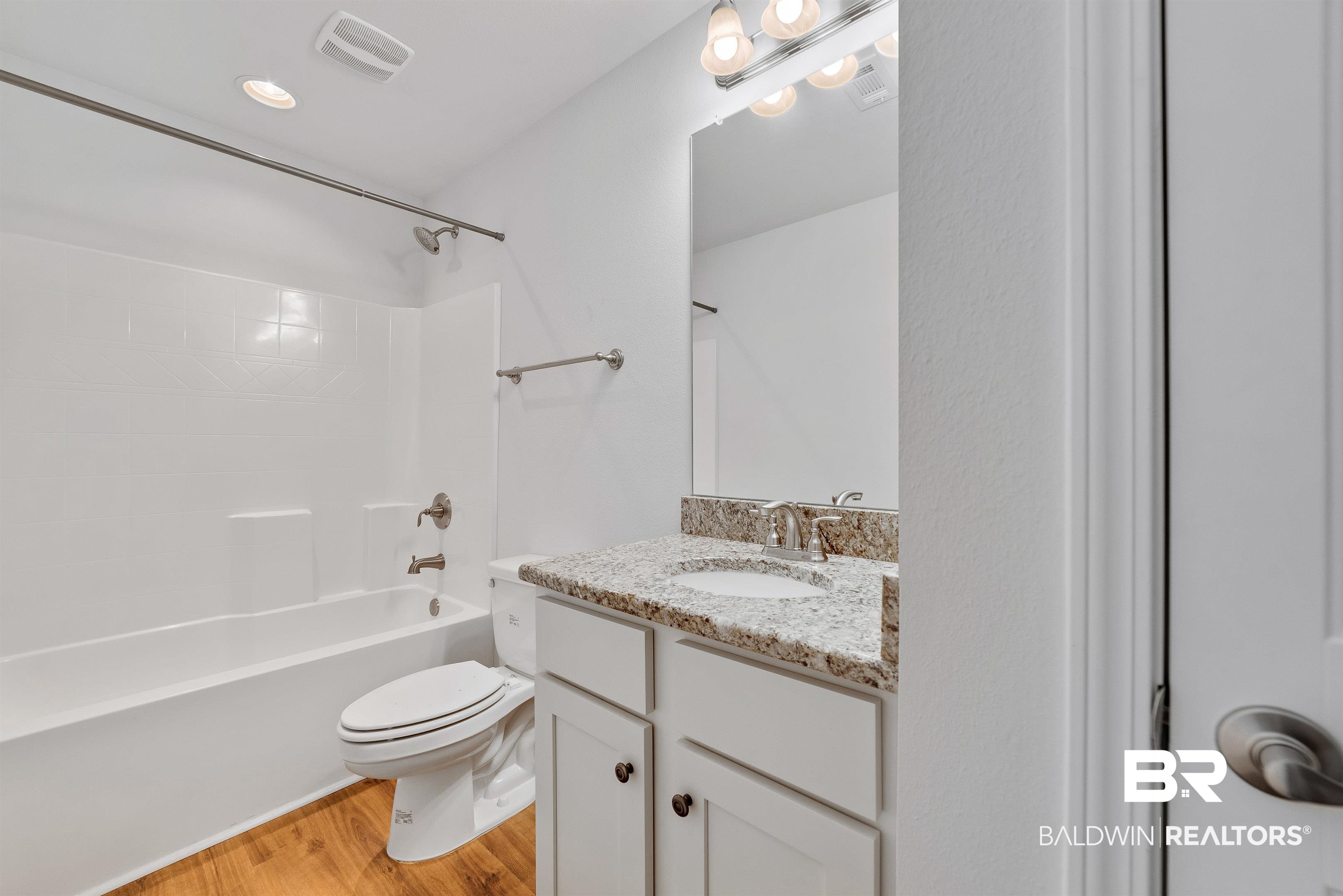 13155 Wishbone Court Foley, AL 36535 - Photo 29 of 39 Full bathroom featuring hardwood / wood-style flooring, shower / bath combination, toilet, and vanity