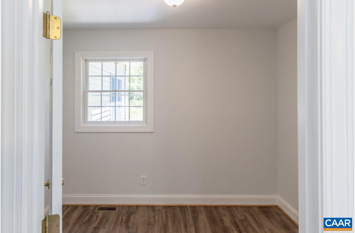 3564 Ridgeview Road Reva, VA 22735 - Photo 28 of 50 a view of an empty room with wooden floor and a window