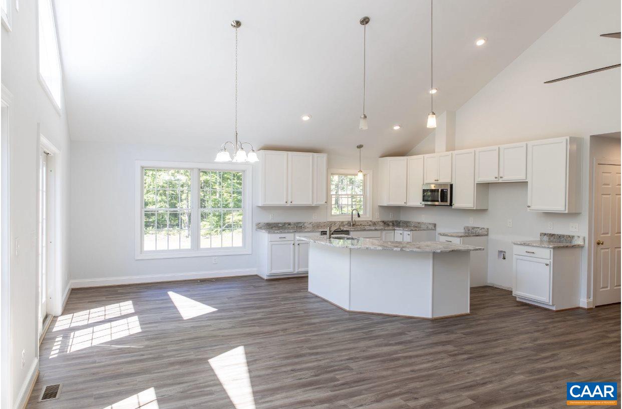 3564 Ridgeview Road Reva, VA 22735 - Photo 30 of 50 a kitchen with kitchen island granite countertop a stove a sink a center island and wooden floor