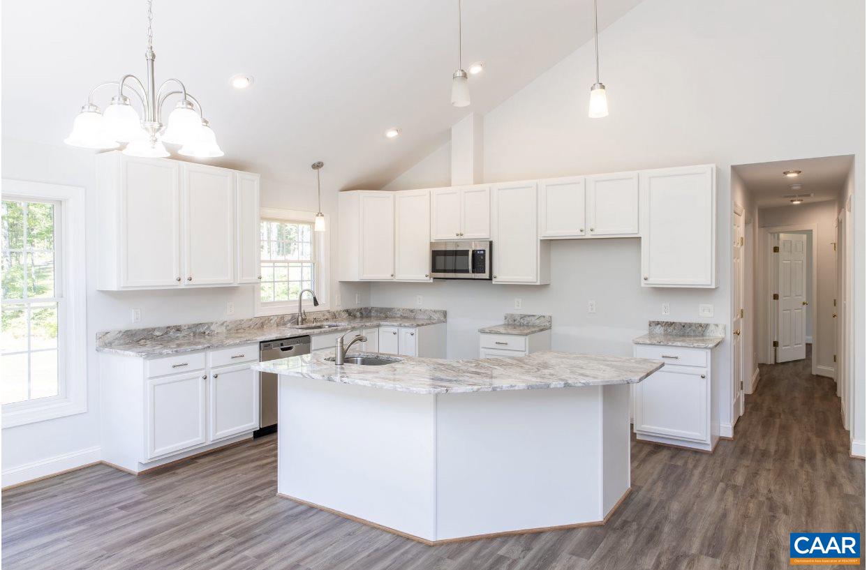 3564 Ridgeview Road Reva, VA 22735 - Photo 34 of 50 a kitchen with kitchen island granite countertop a sink cabinets and wooden floor