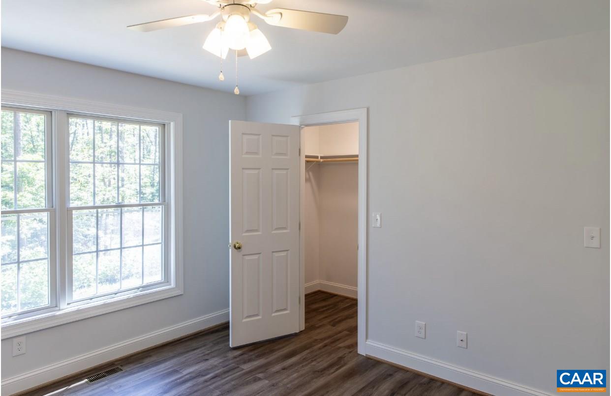 3564 Ridgeview Road Reva, VA 22735 - Photo 39 of 50 an empty room with wooden floor cabinet and windows