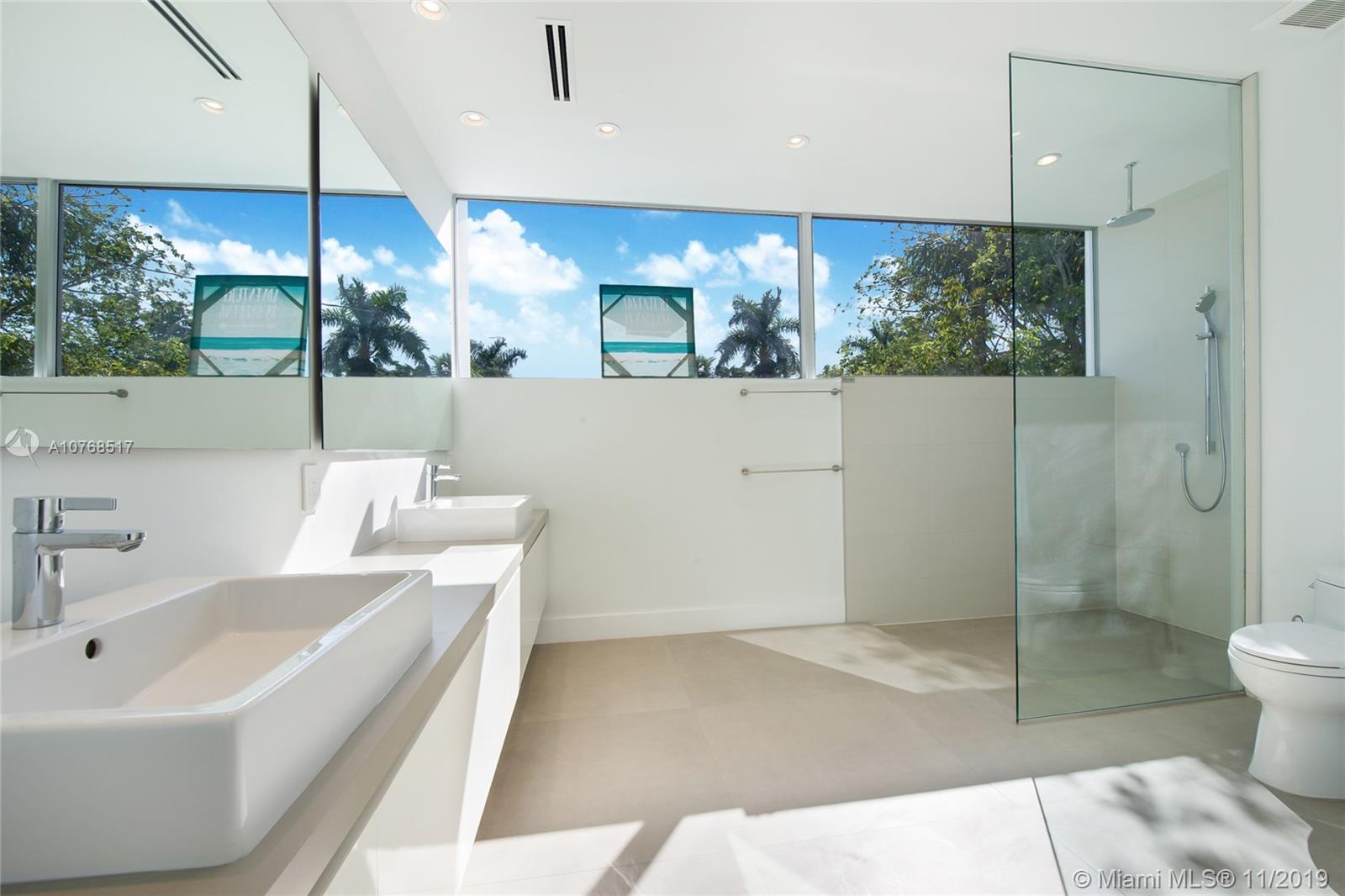 4080 Ensenada Avenue Miami, FL 33133 - Photo 11 of 20 a bathroom with a sink a toilet and shower