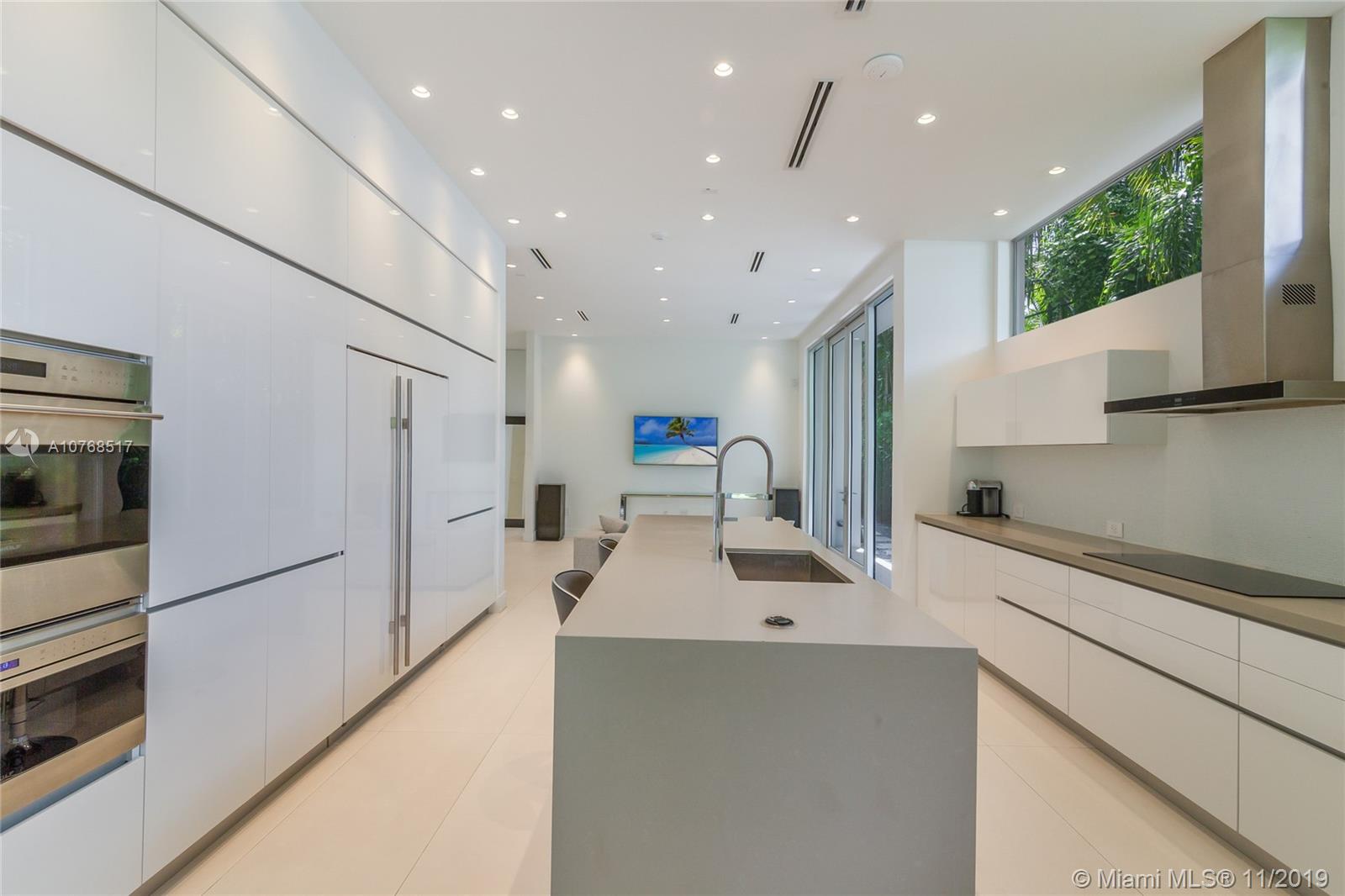 4080 Ensenada Avenue Miami, FL 33133 - Photo 4 of 20 a kitchen with stainless steel appliances a sink stove and refrigerator