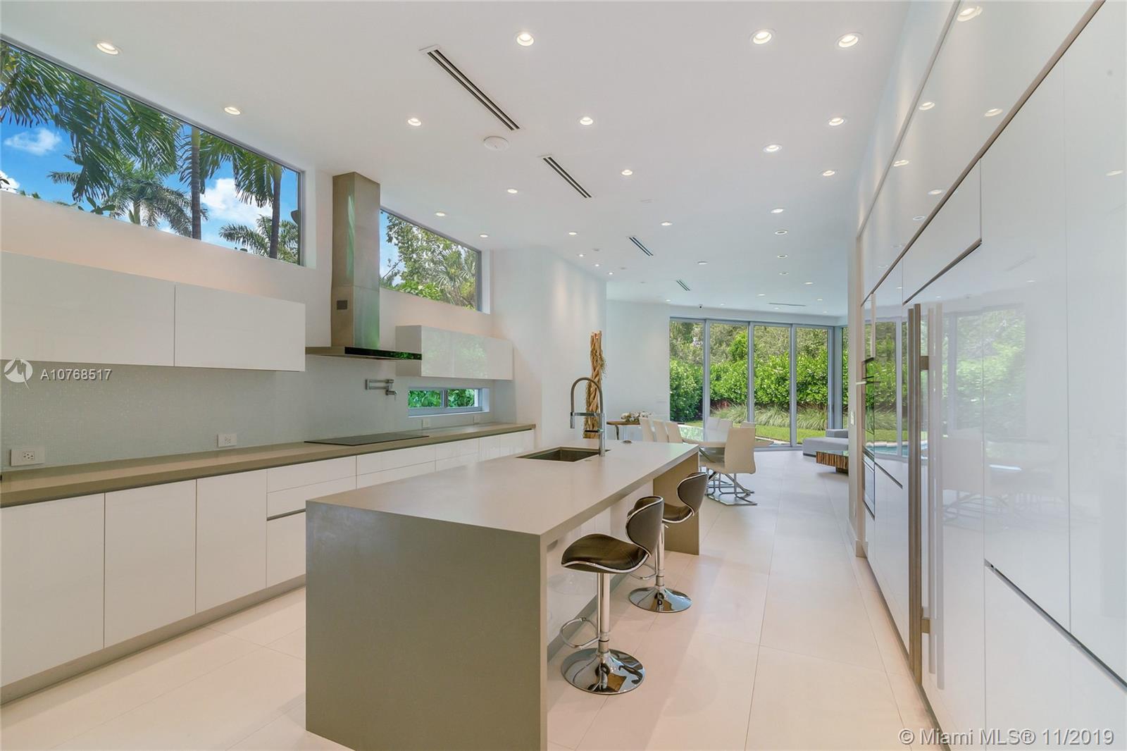 4080 Ensenada Avenue Miami, FL 33133 - Photo 5 of 20 a large kitchen with kitchen island a large window in it