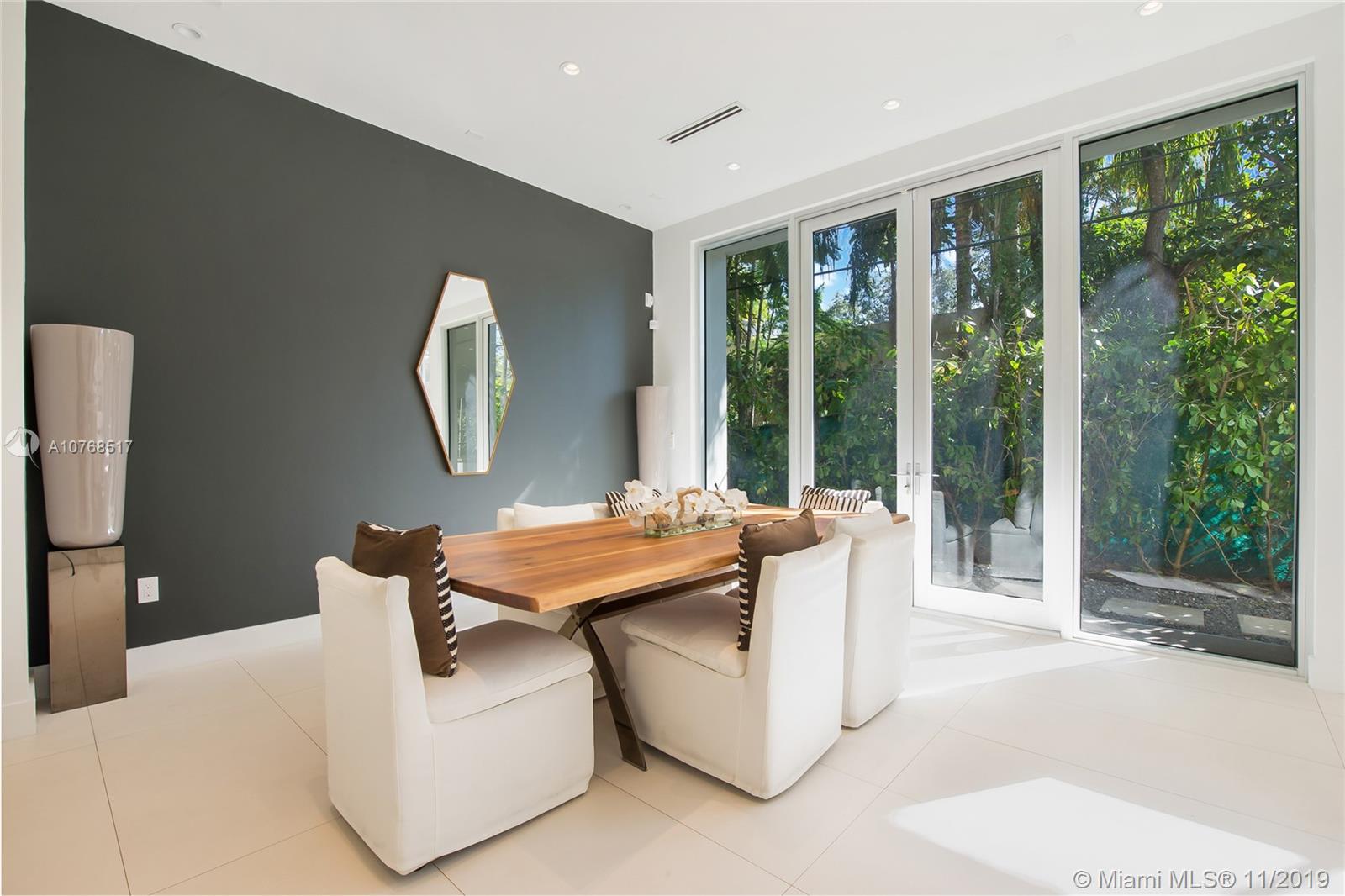 4080 Ensenada Avenue Miami, FL 33133 - Photo 6 of 20 a living room with large windows