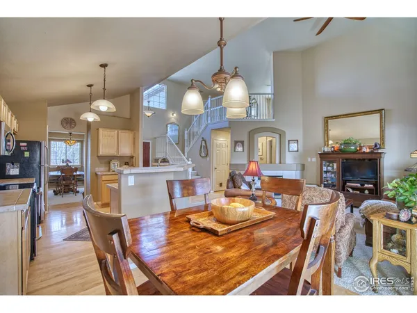 a view of a dining room and livingroom with furniture wooden floor a chandelier