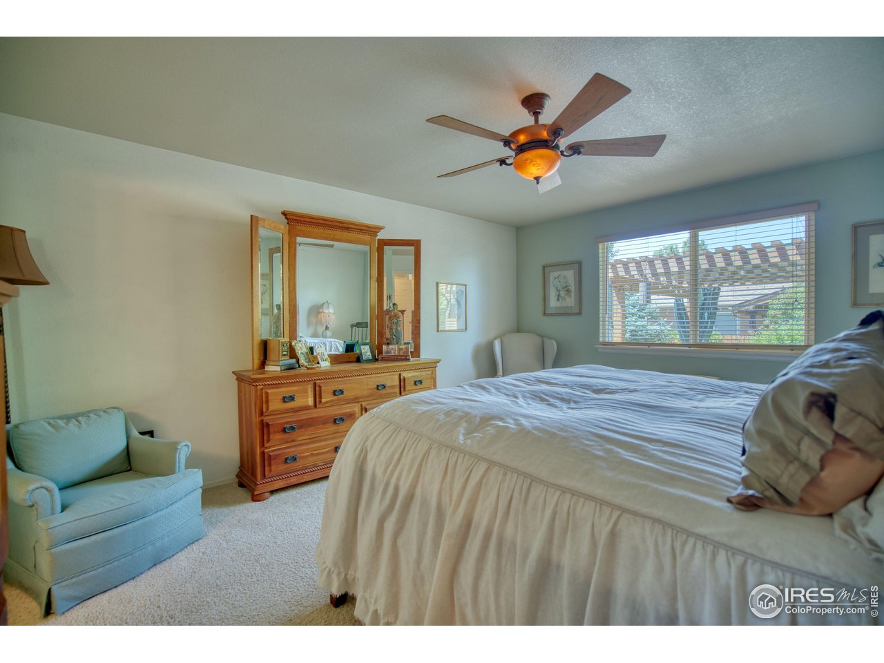 6727 Thistle Ridge Avenue Firestone, CO 80504 - Photo 15 of 40 a bedroom with a bed and a chandelier