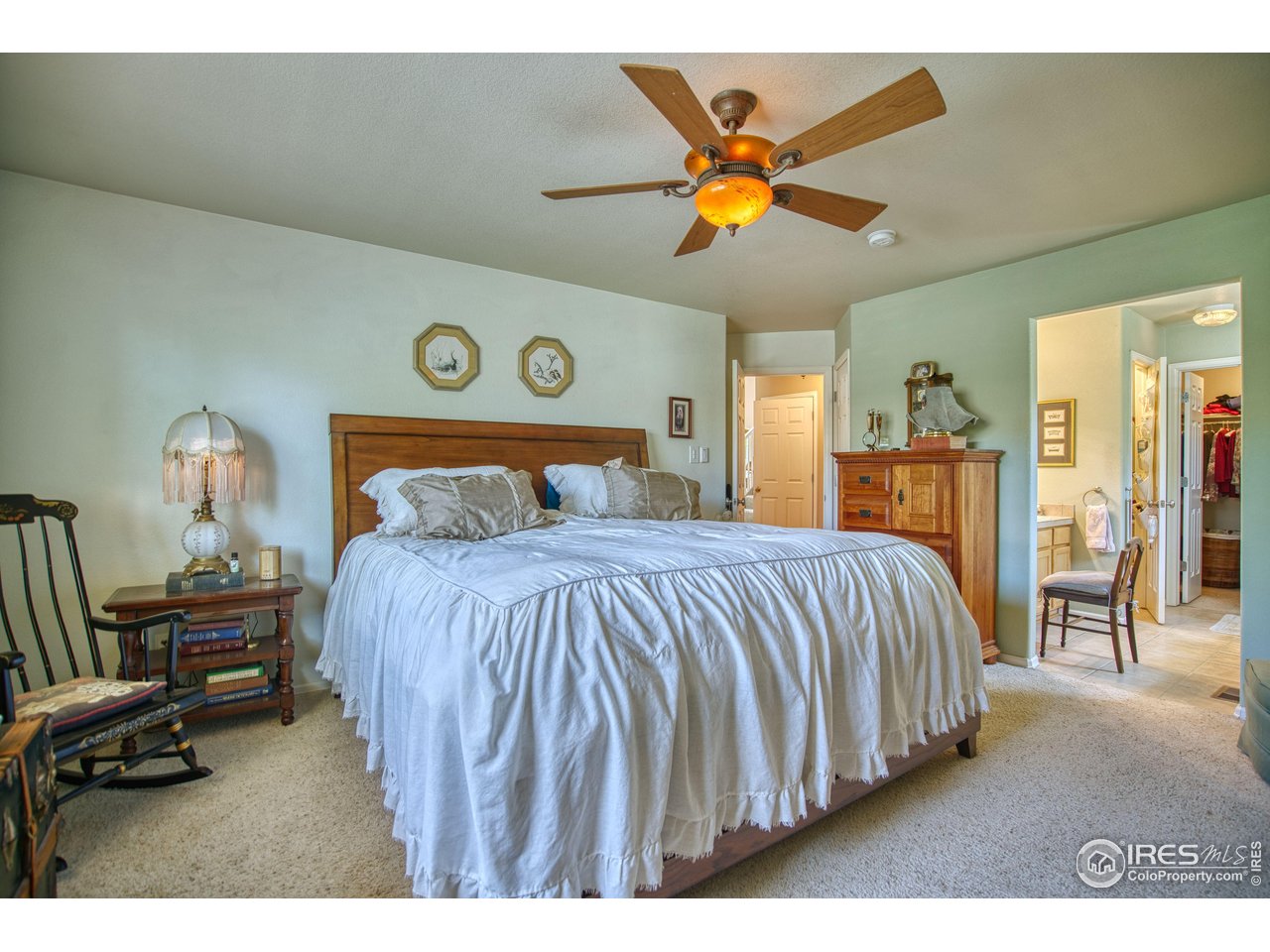 6727 Thistle Ridge Avenue Firestone, CO 80504 - Photo 17 of 40 a bedroom with a bed and a chandelier