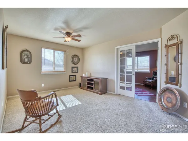 a living room with furniture a flat screen tv and a clock
