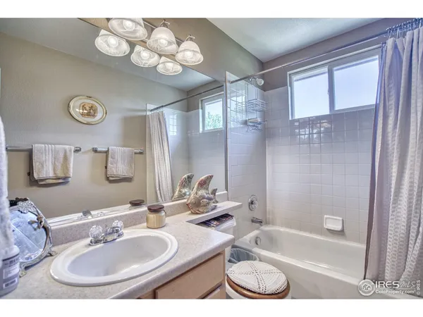 a bathroom with a sink double vanity granite tub and shower