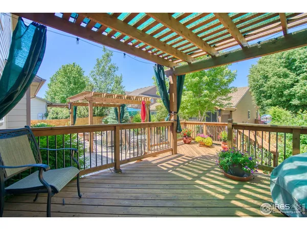 a view of a deck with wooden floor and outdoor seating
