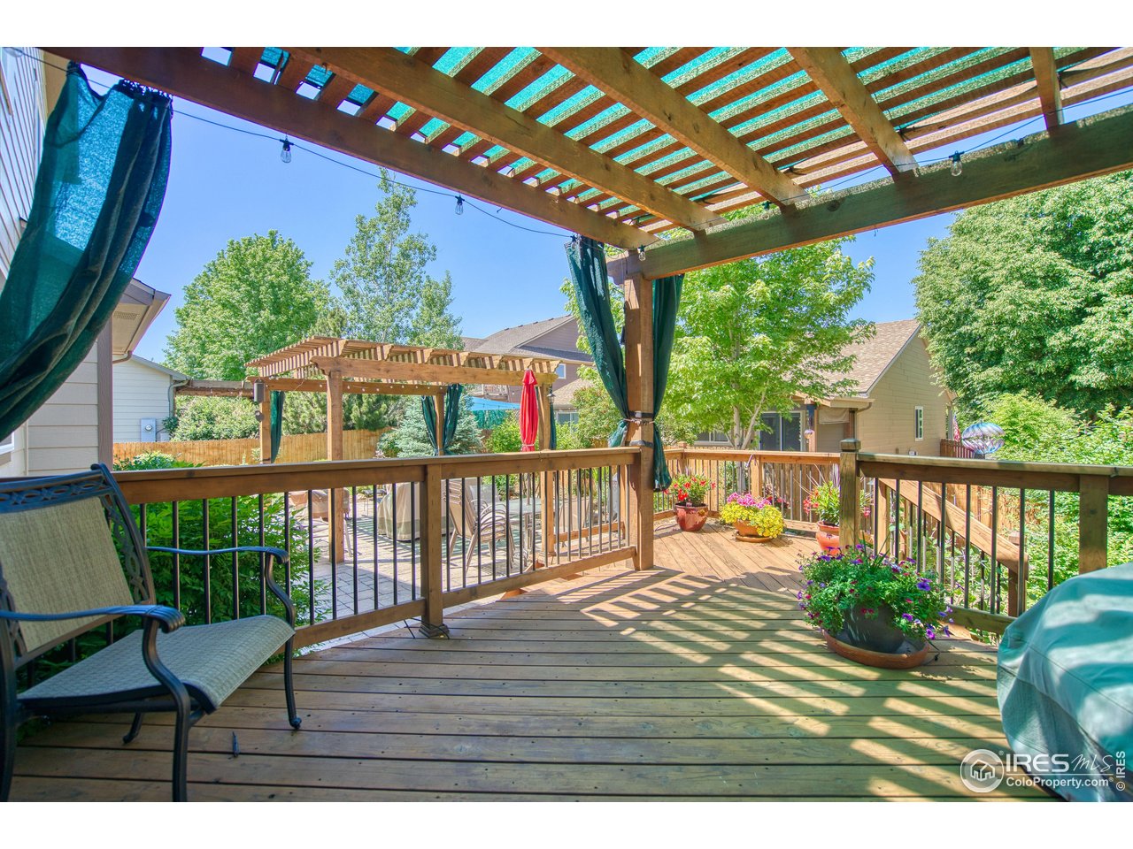 6727 Thistle Ridge Avenue Firestone, CO 80504 - Photo 31 of 40 a view of a deck with wooden floor and outdoor seating