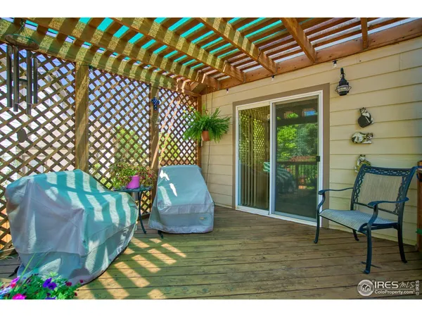 a balcony with chairs and wooden fence