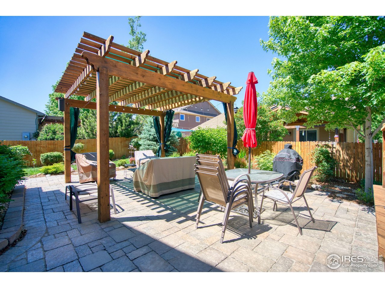 6727 Thistle Ridge Avenue Firestone, CO 80504 - Photo 34 of 40 a patio with glass top table and chairs