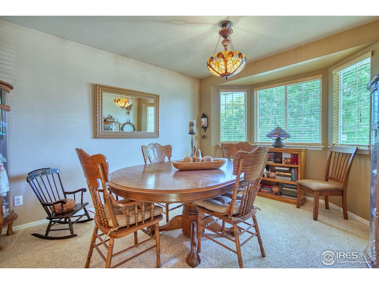6727 Thistle Ridge Avenue Firestone, CO 80504 - Photo 5 of 40 a view of a dining room with furniture window and outside view