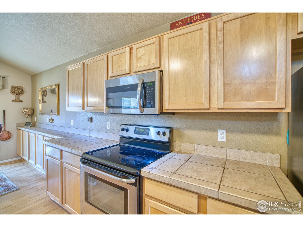 6727 Thistle Ridge Avenue Firestone, CO 80504 - Photo 7 of 40 a kitchen with stainless steel appliances granite countertop a sink stove and cabinets