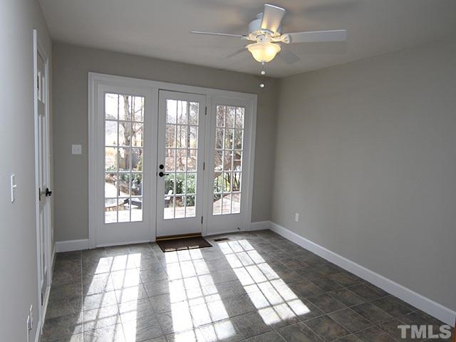 8036 Hawkshead Road Wake Forest, NC 27587 - Photo 20 of 25 Bedroom 2 is on the first floor with an ensuite Full Bath (that is also accessible from the hallway). This bedroom has French doors to the deck, terrace with firepit, and the pool.