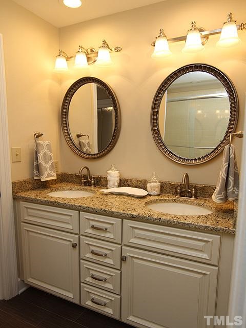 8036 Hawkshead Road Wake Forest, NC 27587 - Photo 22 of 25 This Full Bath is between two bedrooms on 2nd floor. Recently renovated with a new cabinet, (2) under-mounted sinks, granite countertop, brushed nickel finishes, and tiled floor.