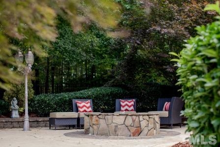 8036 Hawkshead Road Wake Forest, NC 27587 - Photo 5 of 25 Warmth from the fire pit allows pool-side enjoyment during all seasons in North Carolina.