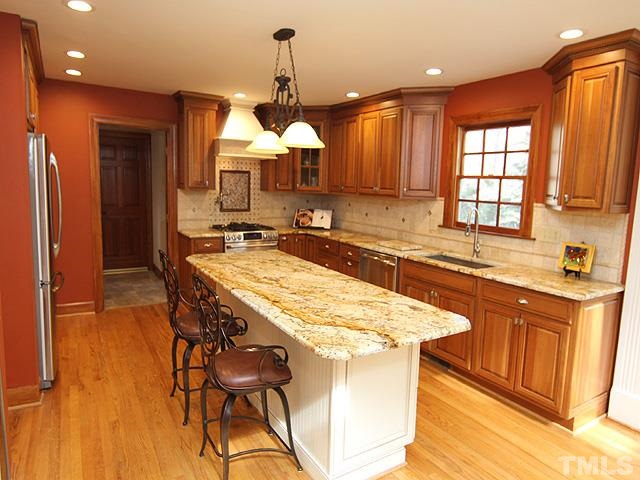 8036 Hawkshead Road Wake Forest, NC 27587 - Photo 9 of 25 Gorgeous Kitchen is custom-designed for multiple cooks and entertaining. Appliances include Gas Range, Microwave Drawer, Wine Cooler, SS Dishwasher + Icemaker and Drink Refrigerator in the Sunroom.