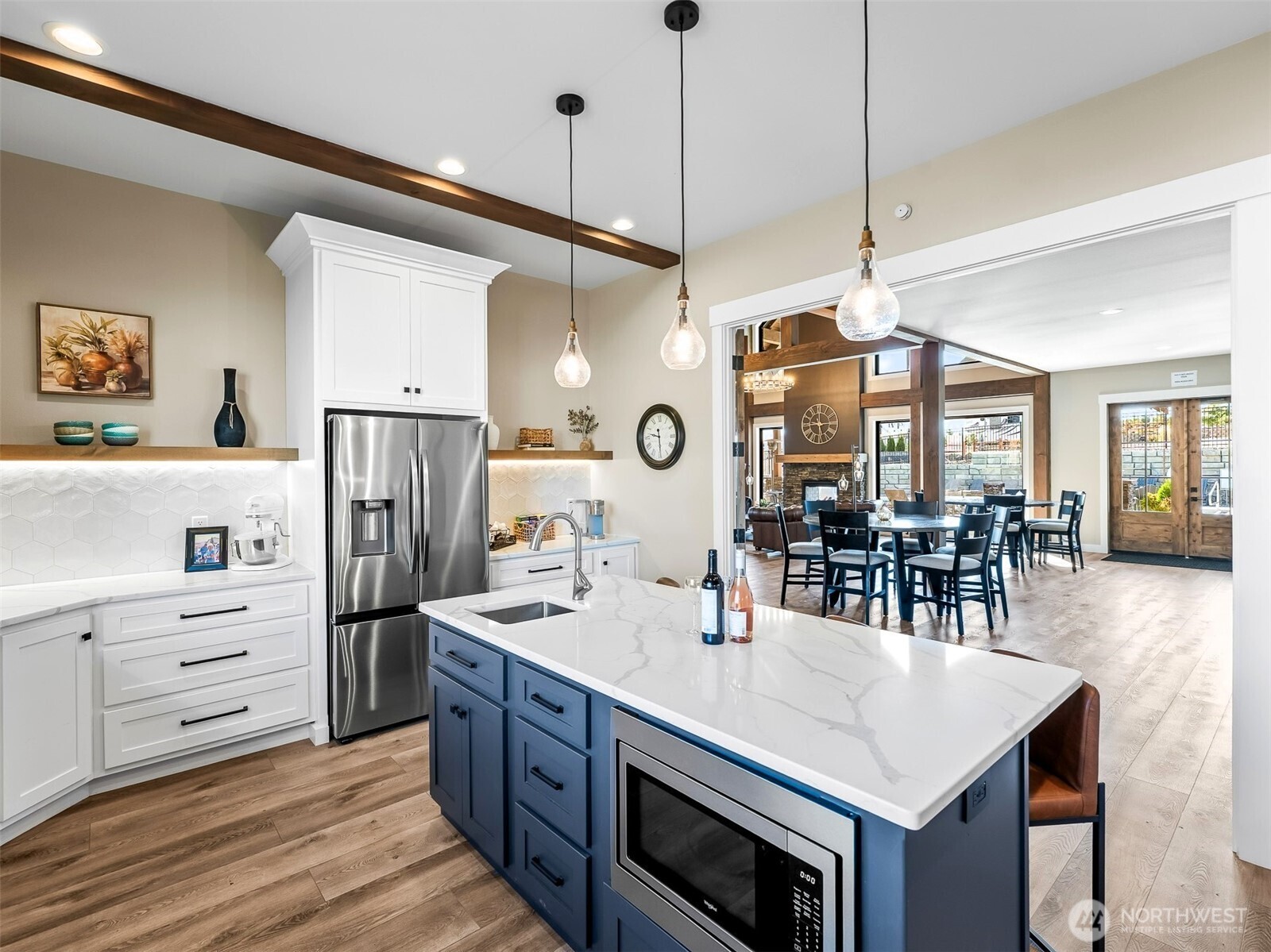 1769 Naches Wenas Road, Unit 123 Selah, WA 98942 - Photo 8 of 10 a kitchen with stainless steel appliances kitchen island granite countertop a table chairs and a refrigerator