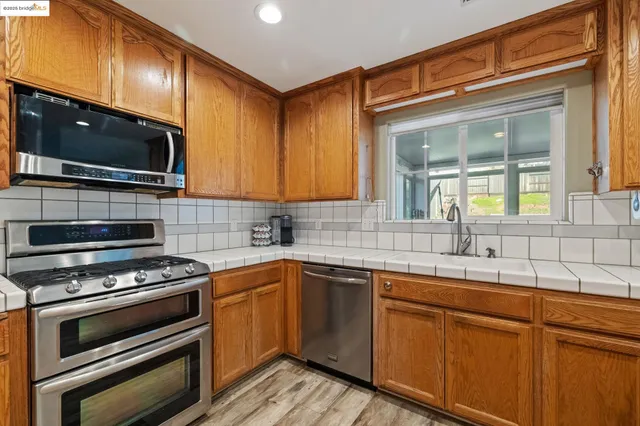 a kitchen with a sink stove and microwave