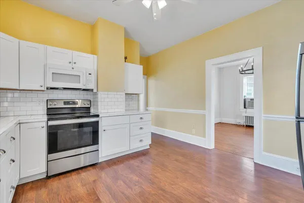 a kitchen with granite countertop a stove and a refrigerator