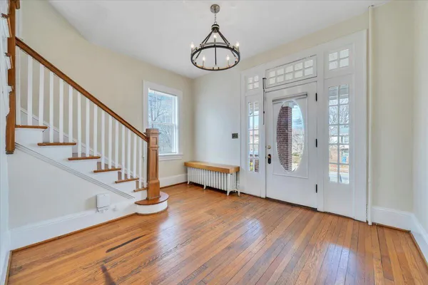 a view of an entryway with wooden floor and door