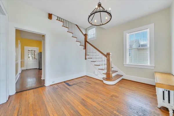 a view of an entryway with wooden floor