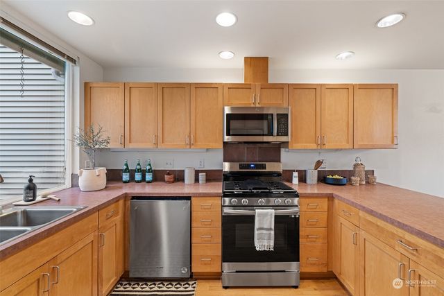 a view of a balcony with chairs and wooden floor
