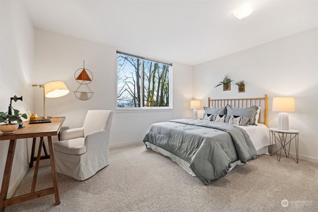 a bathroom with a granite countertop sink mirror vanity and toilet