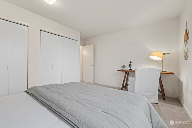 a bedroom with bed and a large window