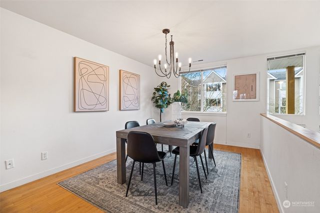 a large kitchen with stainless steel appliances granite countertop a stove a sink dishwasher and a refrigerator with wooden floor