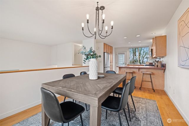 a kitchen with stainless steel appliances granite countertop a stove top oven a sink dishwasher a refrigerator and a microwave