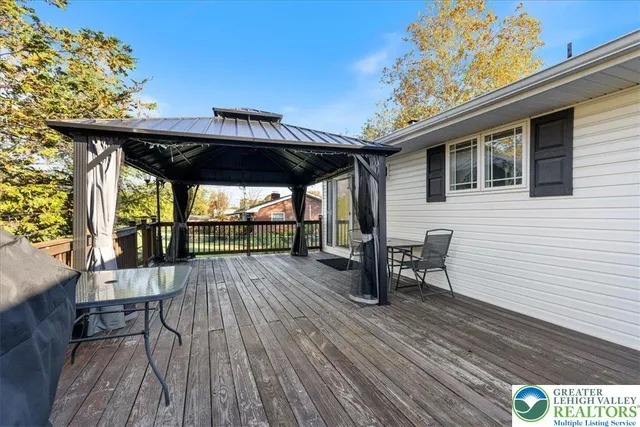 a view of a house with wooden deck