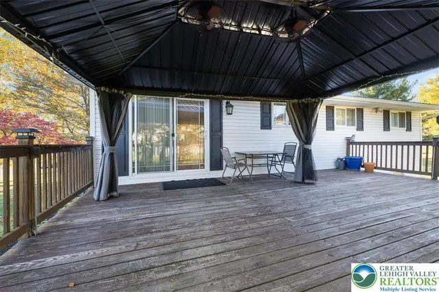 a view of a couches and a table in a yard