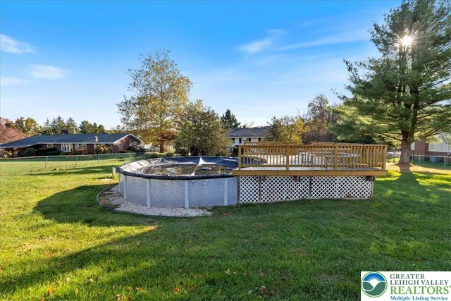 a view of a swimming pool with a yard