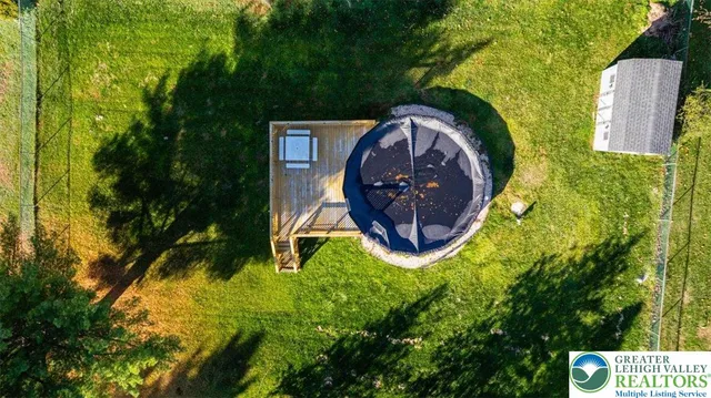 a view of a house with a yard and tree s