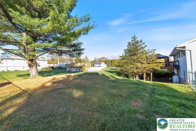 a view of swimming pool with a garden and plants