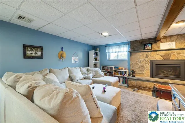 a living room with furniture and a book shelf