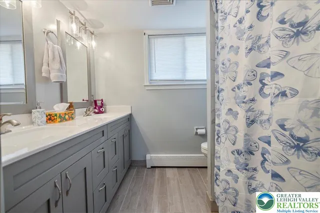 a white toilet sitting next to a bathroom sink