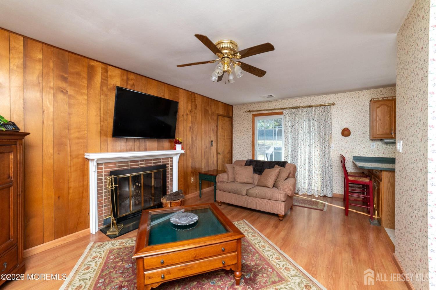 2 Brentwood Road Old Bridge, NJ 07747 - Photo 14 of 30 a living room with furniture a flat screen tv and a fireplace
