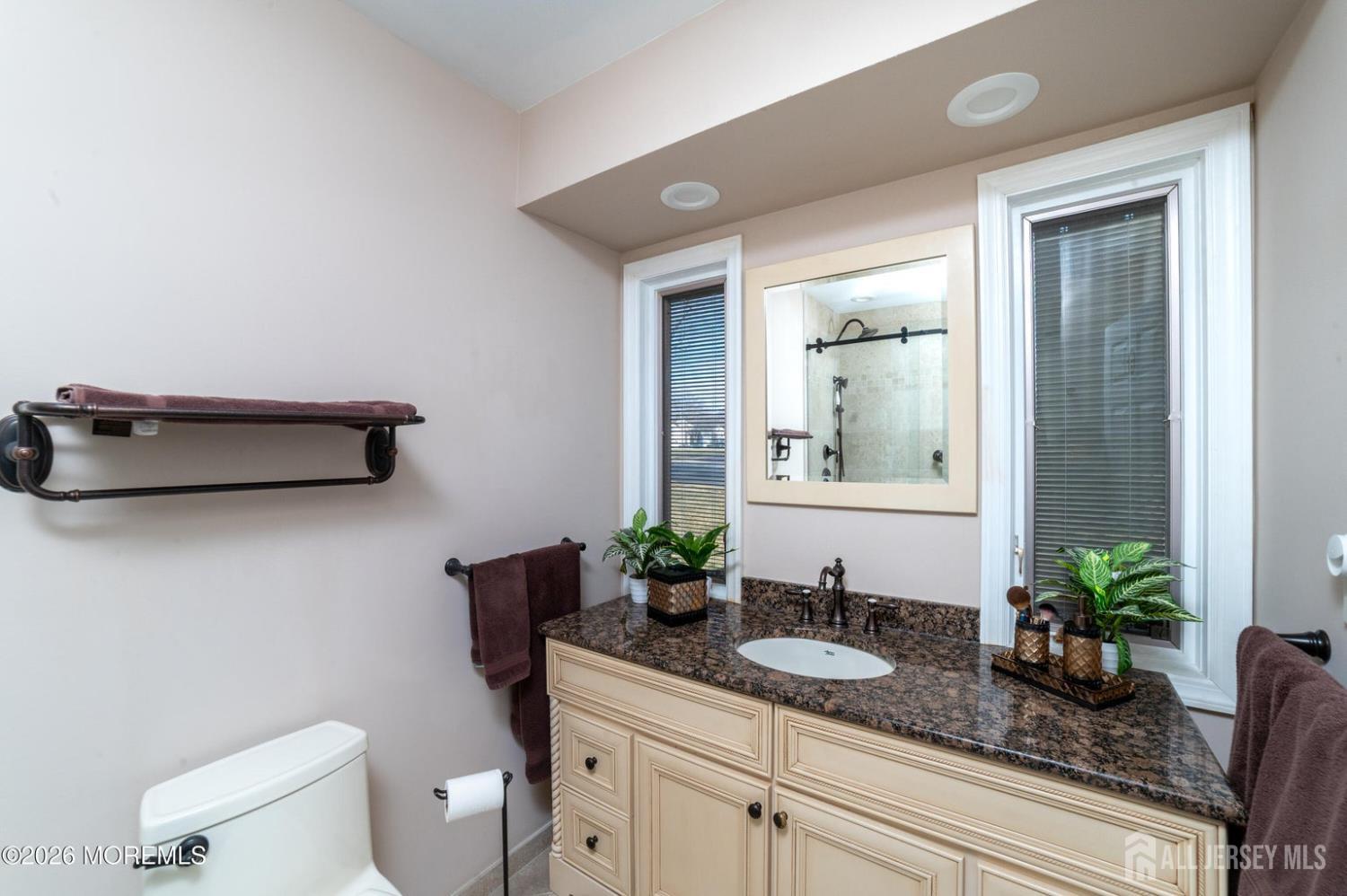 2 Brentwood Road Old Bridge, NJ 07747 - Photo 17 of 30 a bathroom with a granite countertop sink a toilet and mirror