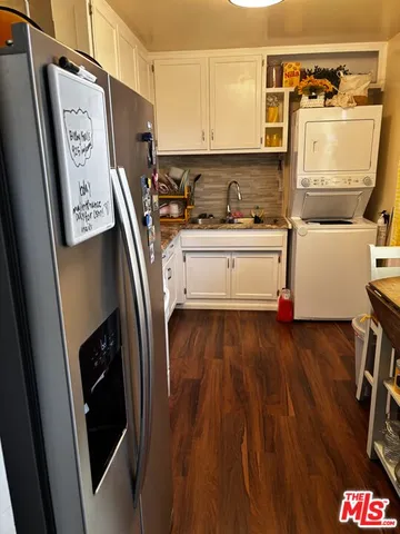 a view of appliances and wooden floor